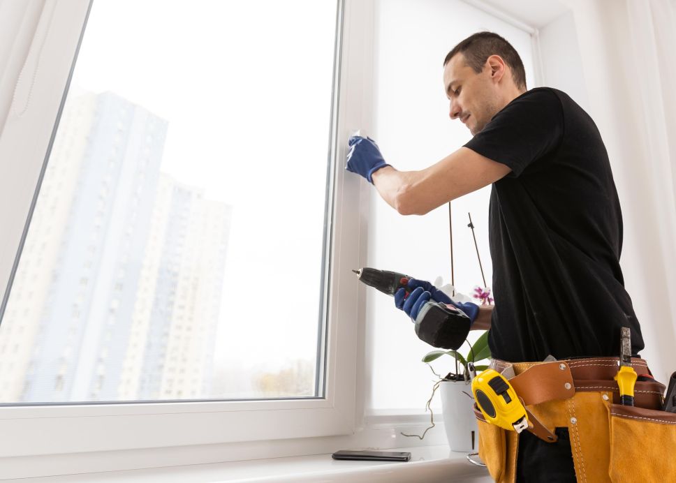 a window installer putting in replacement windows