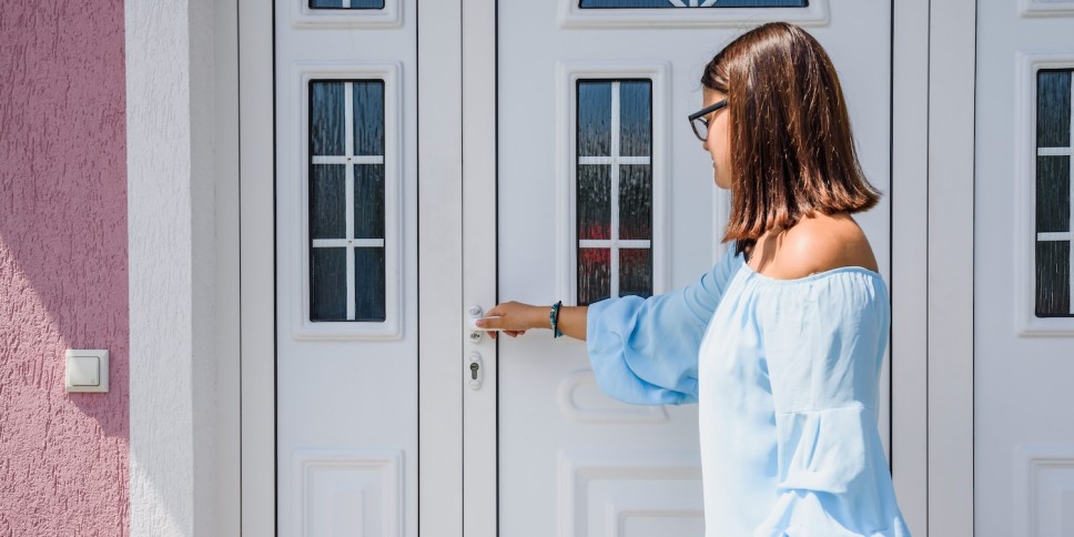 A woman entering a beautiful new front door
