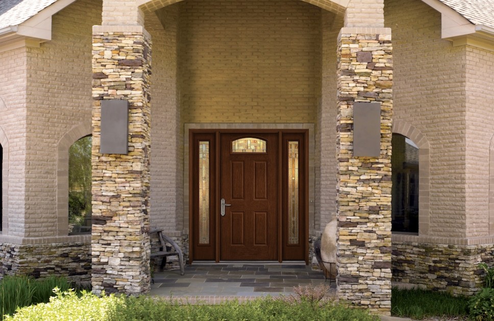 A front door with decorative glass panels