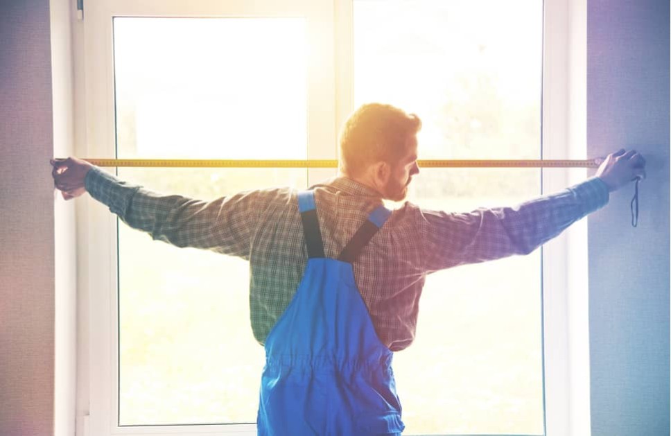 A man completing a professional window installation