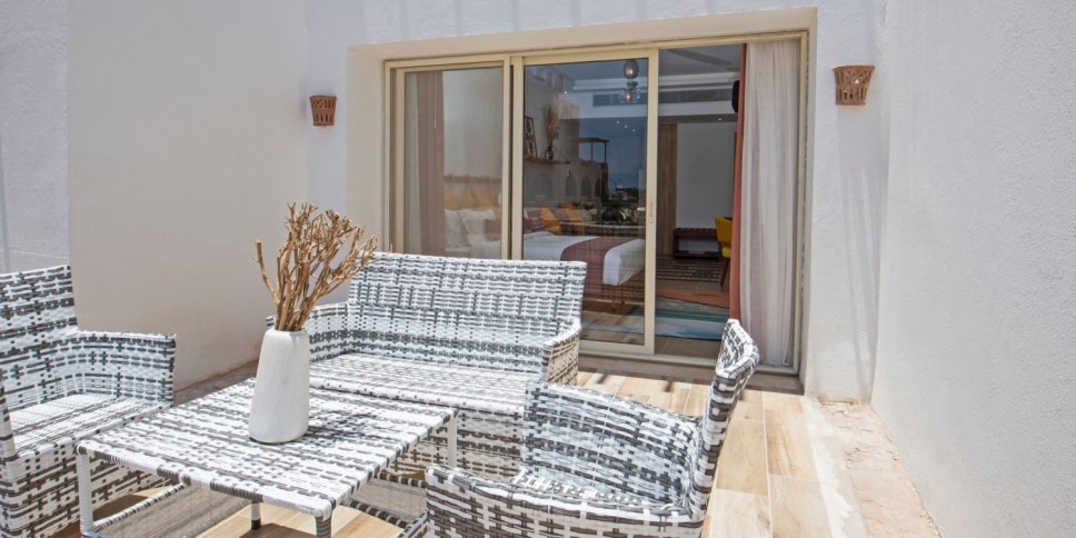 Sliding patio doors leading to a beachy patio design