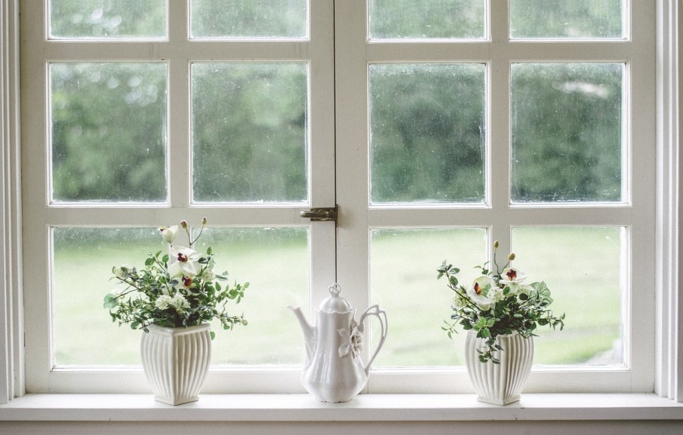 energy efficient windows with flowers and a teapot on the windowsill